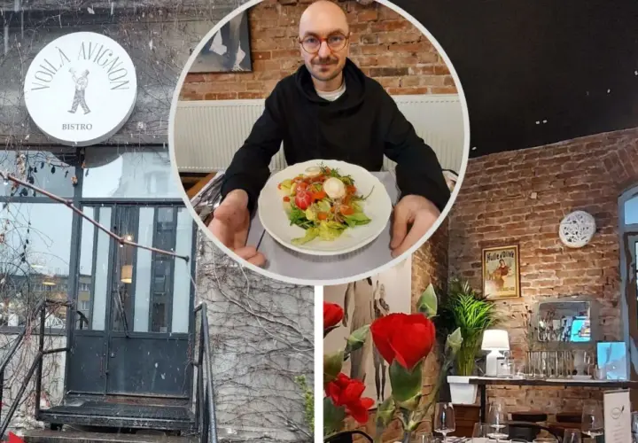 Voila, co znaczy to bistro! Mężczyzna z okularami prezentuje sałatkę w przytulnym wnętrzu z ceglanymi ścianami i stylowymi lampami.
