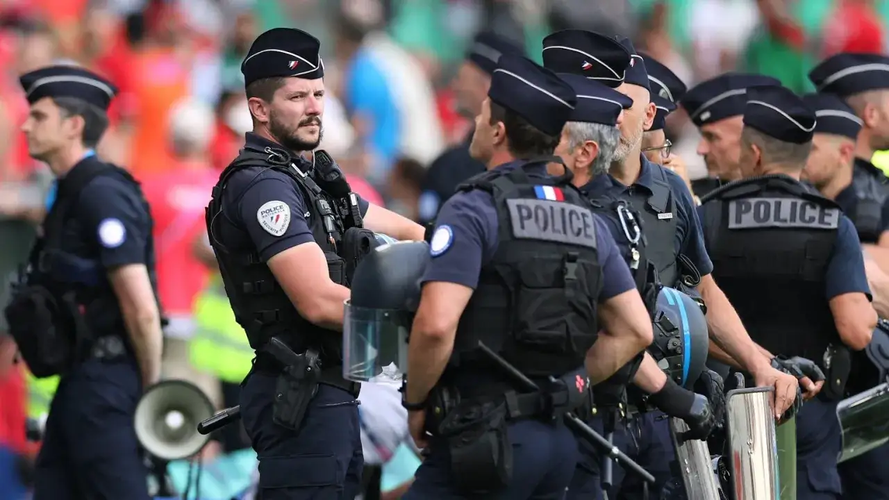 Francuska policja w pełnym rynsztunku, gotowa do akcji. Mundury, kamizelki taktyczne i hełmy świadczą o ich profesjonalizmie.